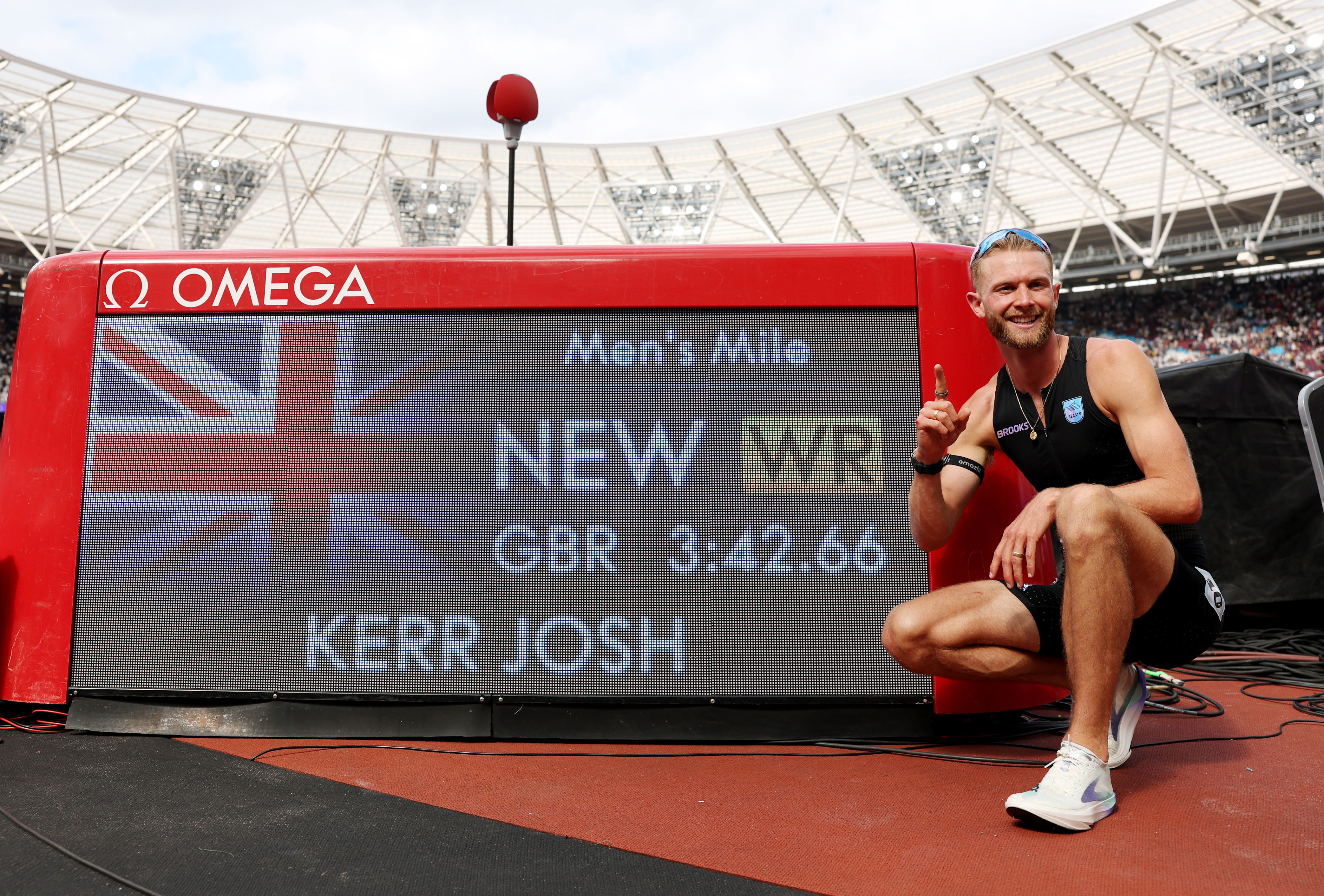 Josh Kerr celebrates after setting the new 1-mile world record, shattering the previous mark, which had stood for 27 years.