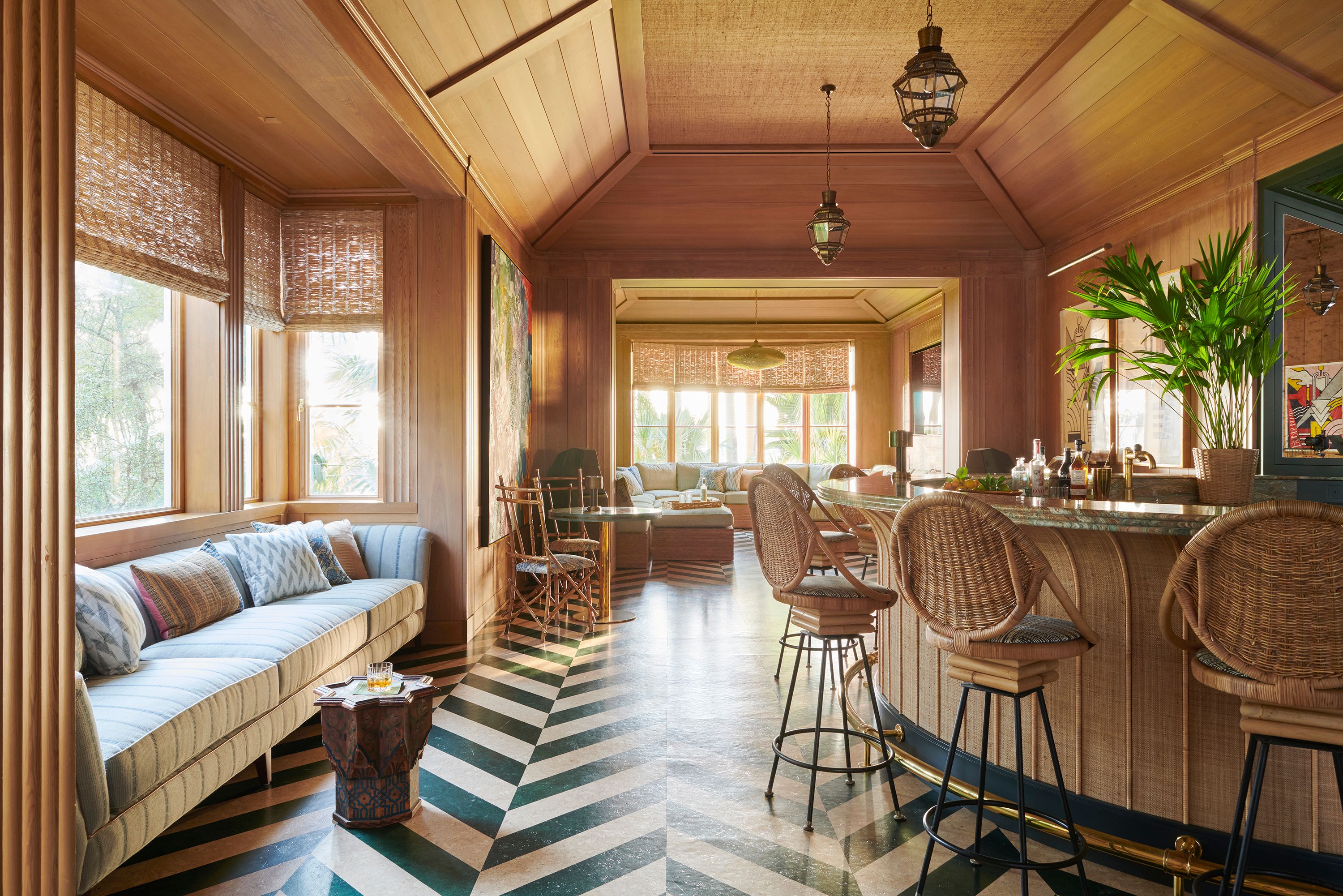 The bar was intended as a primary party space, with hidden speakers and a DJ booth. Kemble wanted it to feel like guests were just off the coast of Florida, maybe in Havana, on a breezy night the year this house was built. The antiqued mirror was made in New York.