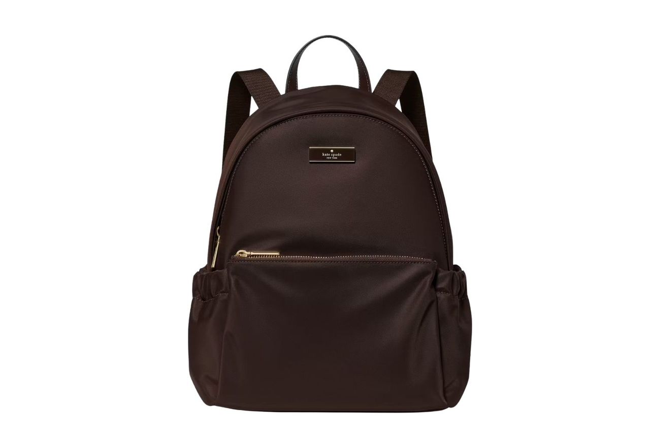 A solidcolored backpack featuring a front zipper pocket and a structured design includes a logo plaque at the top