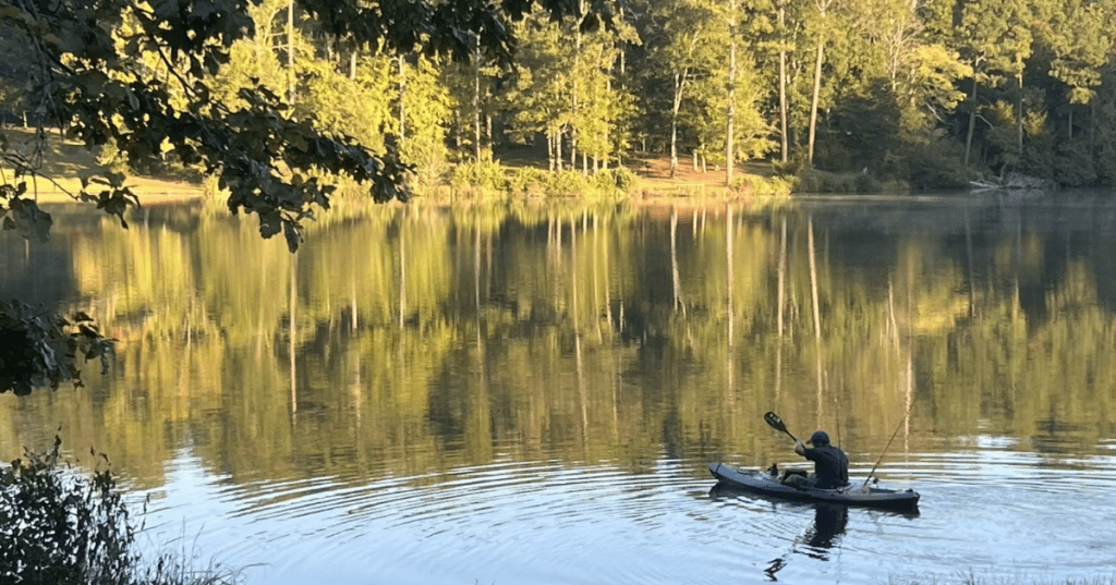 A kayaker paddles through a mountain lake in South Carolina.