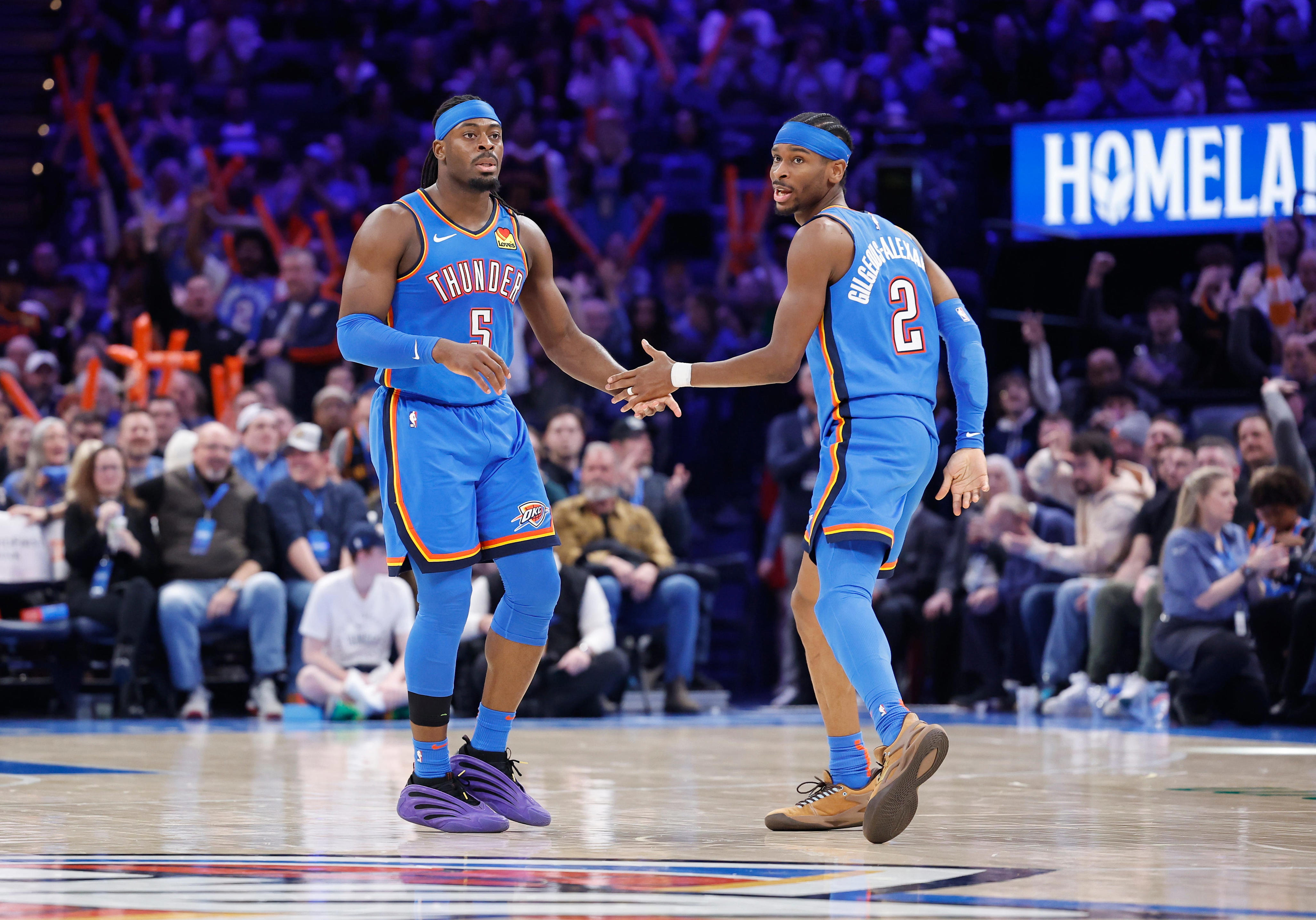 Feb 12, 2025; Oklahoma City, Oklahoma, USA; Oklahoma City Thunder guard Luguentz Dort (5) and guard Shai Gilgeous-Alexander (2) celebrate after a play against the Miami Heat during the second half at Paycom Center. Mandatory Credit: Alonzo Adams-Imagn Images