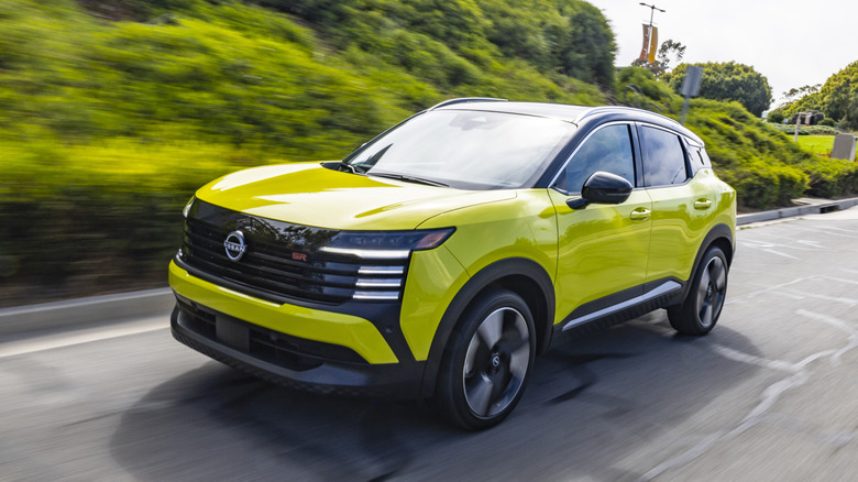 A yellow 2026 Nissan Kicks on a roadway.