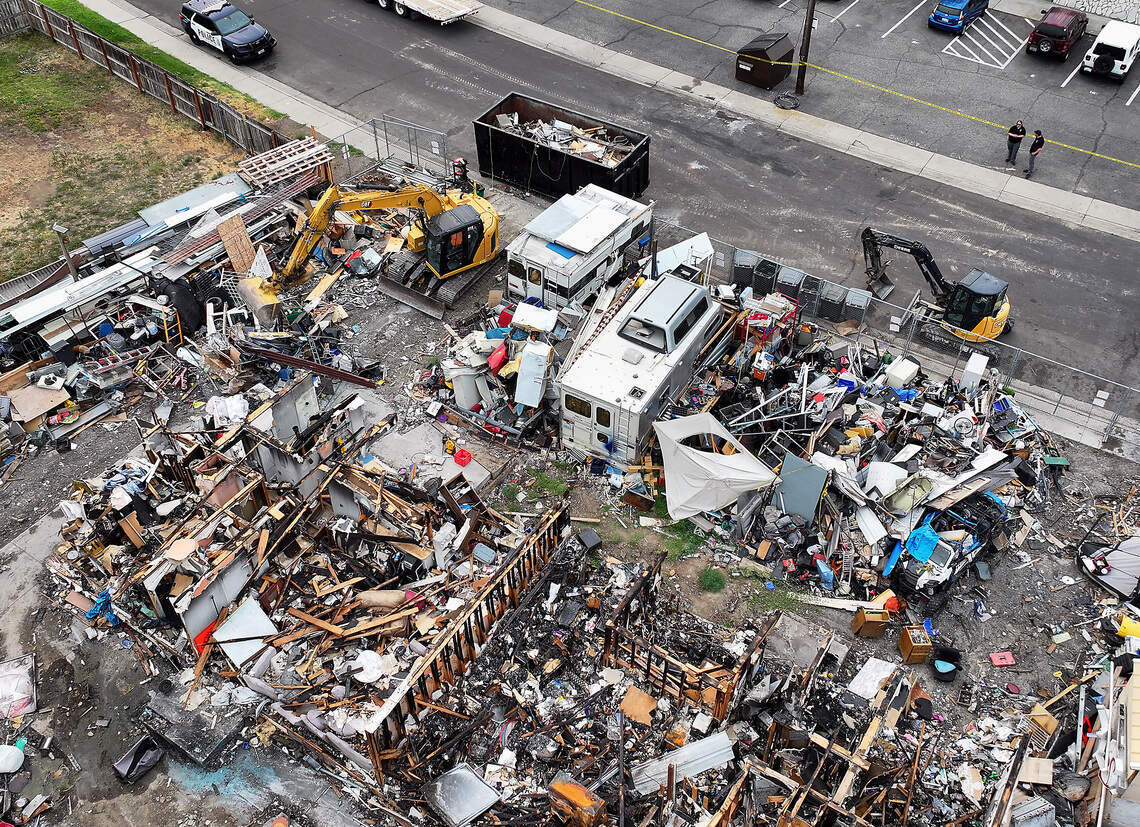 An excavator operated by a local contractor hired by the city of Richland begins cleanup and removal Monday morning of junk, vehicles and debris from 2100 Pullen Street in Richland.