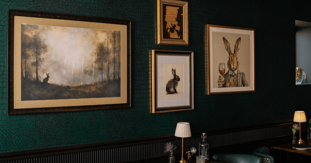 The interior of The Rabbit Hole restaurant in Conshohocken, PA. Various framed photos of rabbits line the walls above the tables.