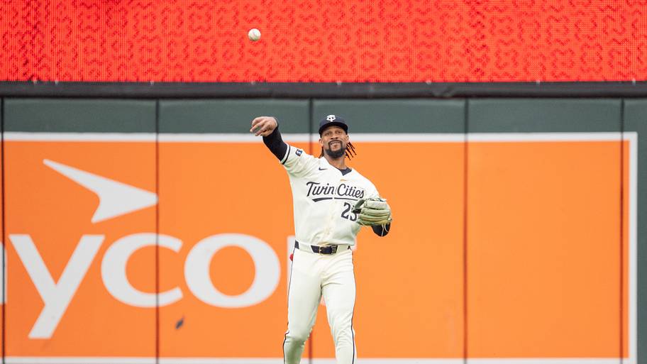 Byron Buxton throws the ball after catching a fly ball
