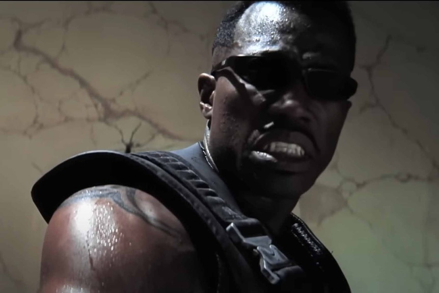 Blade (Wesley Snipes) grimaces in sunglasses in Blade (1998).
