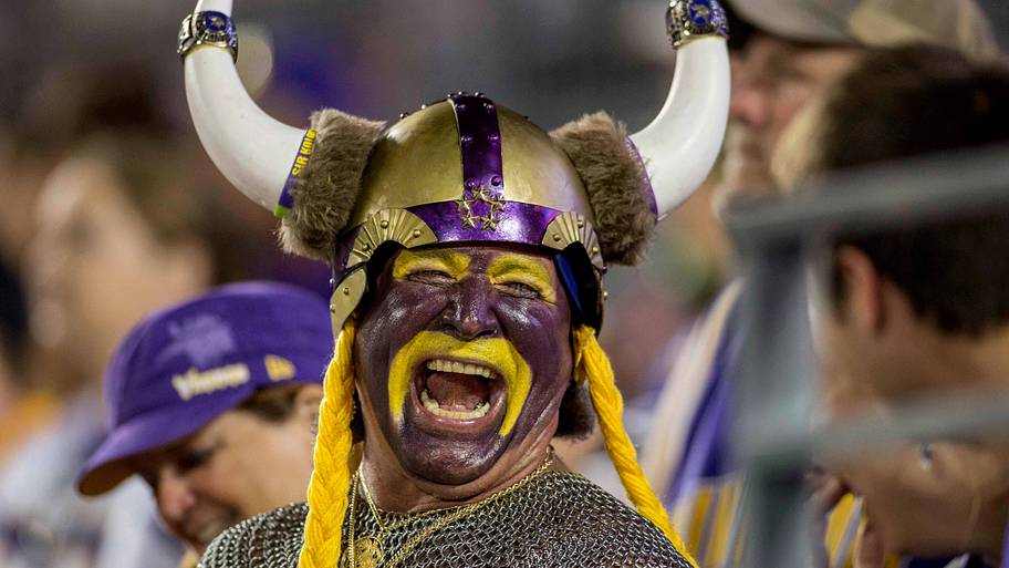 Vikings fan in costume laughing.