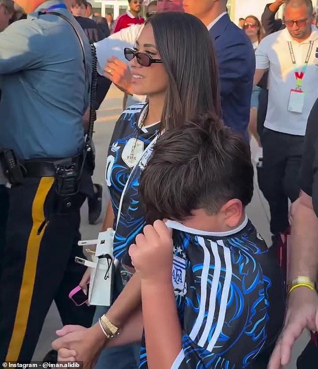 She walked hand-in-hand with her son, Mateo, who wiped away tears with his father's kit