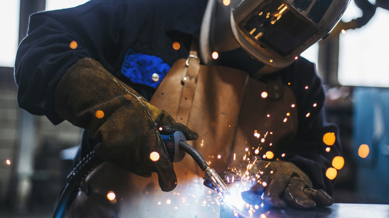 welder in action while wearing protective gear