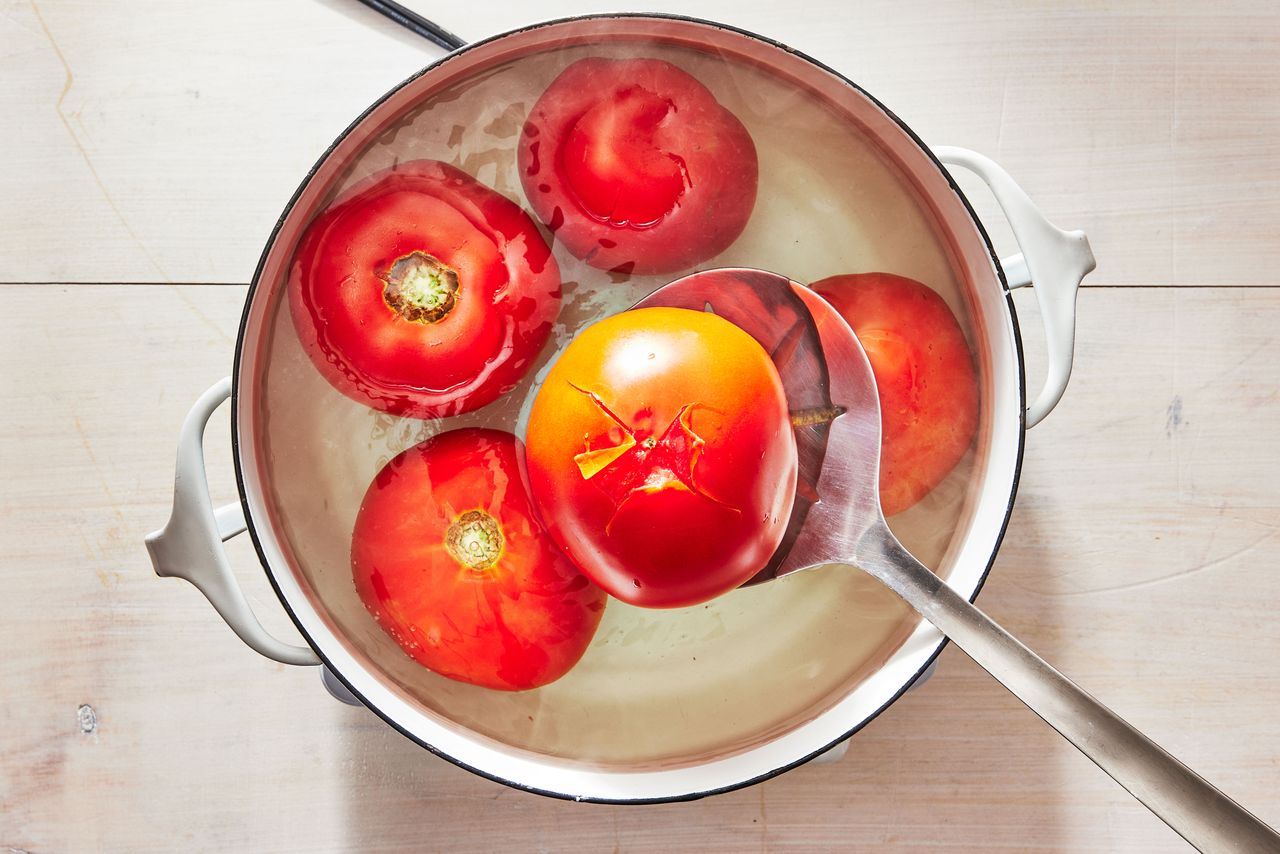 Southern Living How to Peel Tomatoes skin peeling back from where the tomatoes were scored