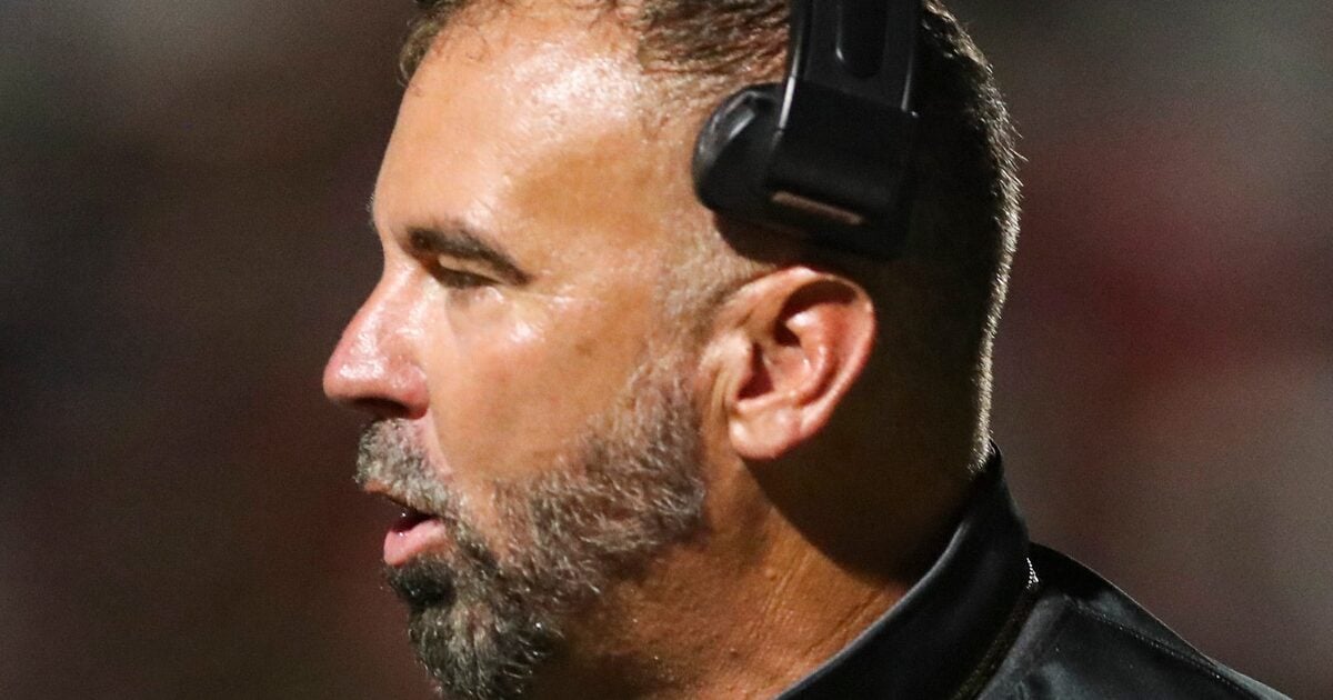 Barron Collier Cougars head coach Brannon Tidwell claps with the team during the third quarter of the season opener against the Immokalee Indians at Gary Bates Stadium in Immokalee, Fla., on Friday, Aug. 22, 2025.