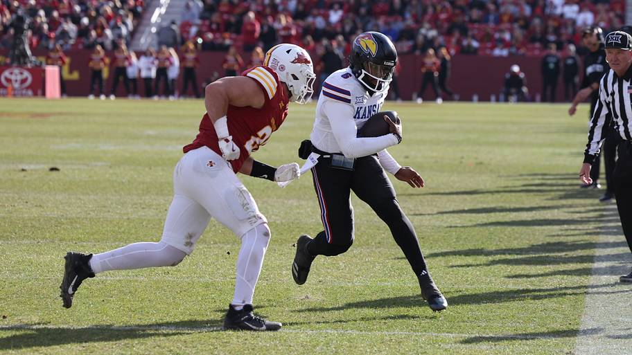 Iowa State Cyclones linebacker Caleb Bacon pursues Kansas Jayhawks quarterback Jalon Daniels.
