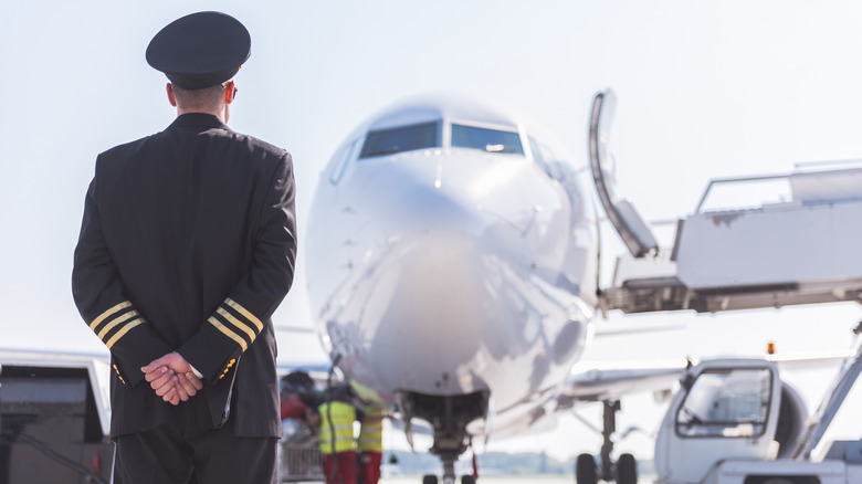 Pilot facing a commercial jet