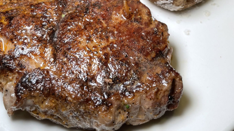 Steak from outback steakhouse on a white plate