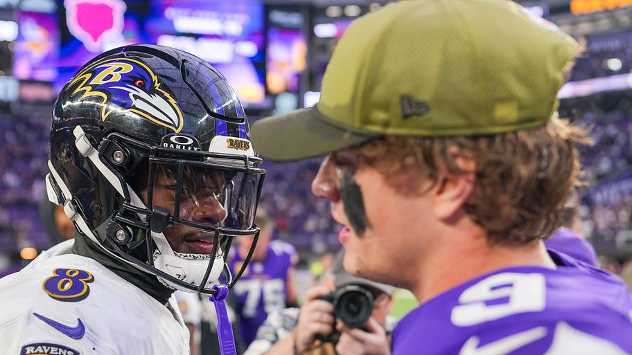 JJ McCarthy and Lamar Jackson shake hands.