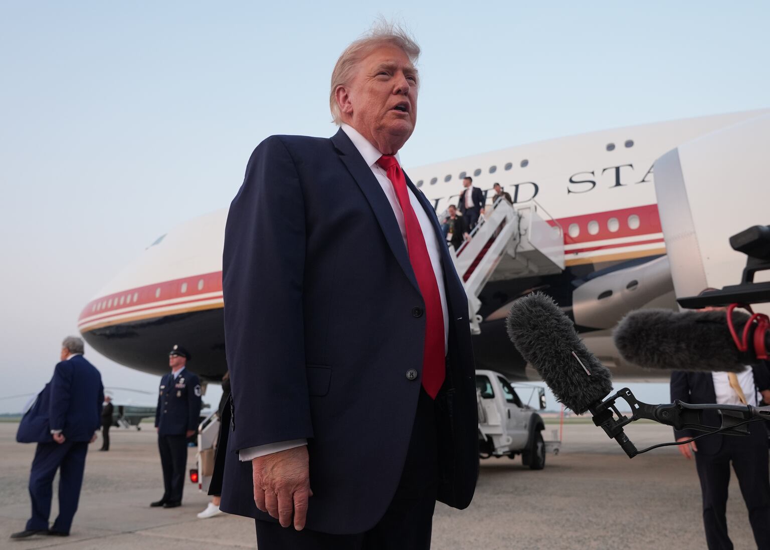 President Donald Trump speaks to reporters as he exits Air Force One (Jacquelyn Martin/AP)