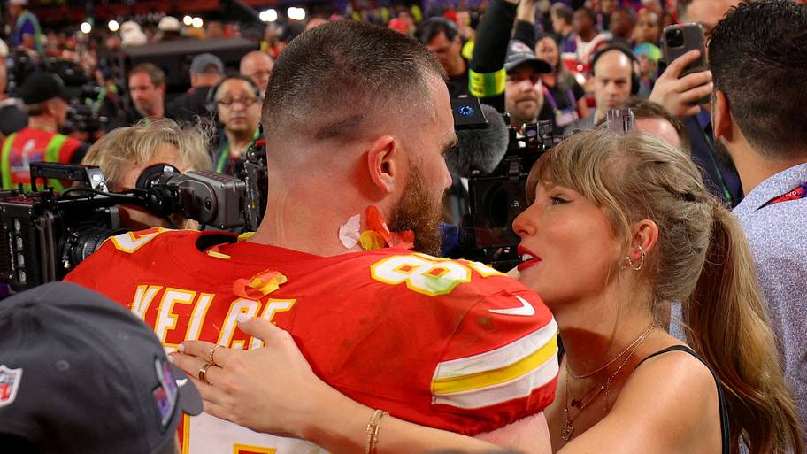 Travis Kelce celebrates with partner Taylor Swift