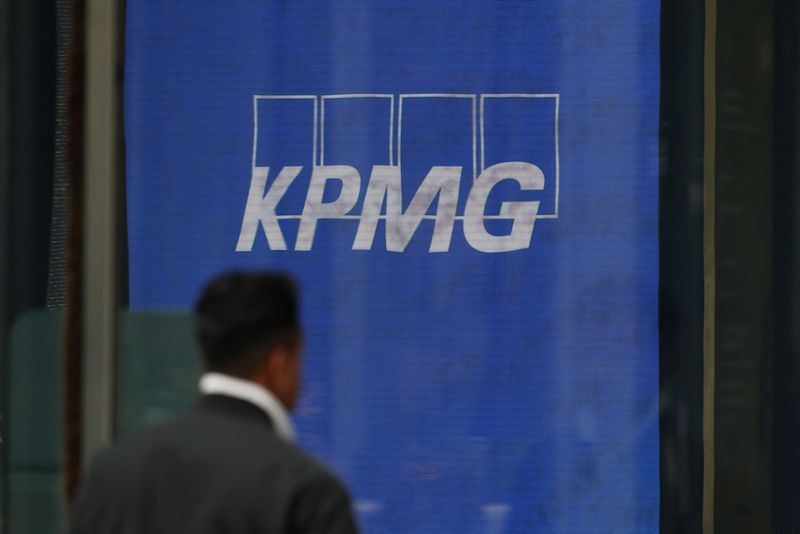 A man walks past a KPMG logo displayed at the company’s headquarters in Sydney