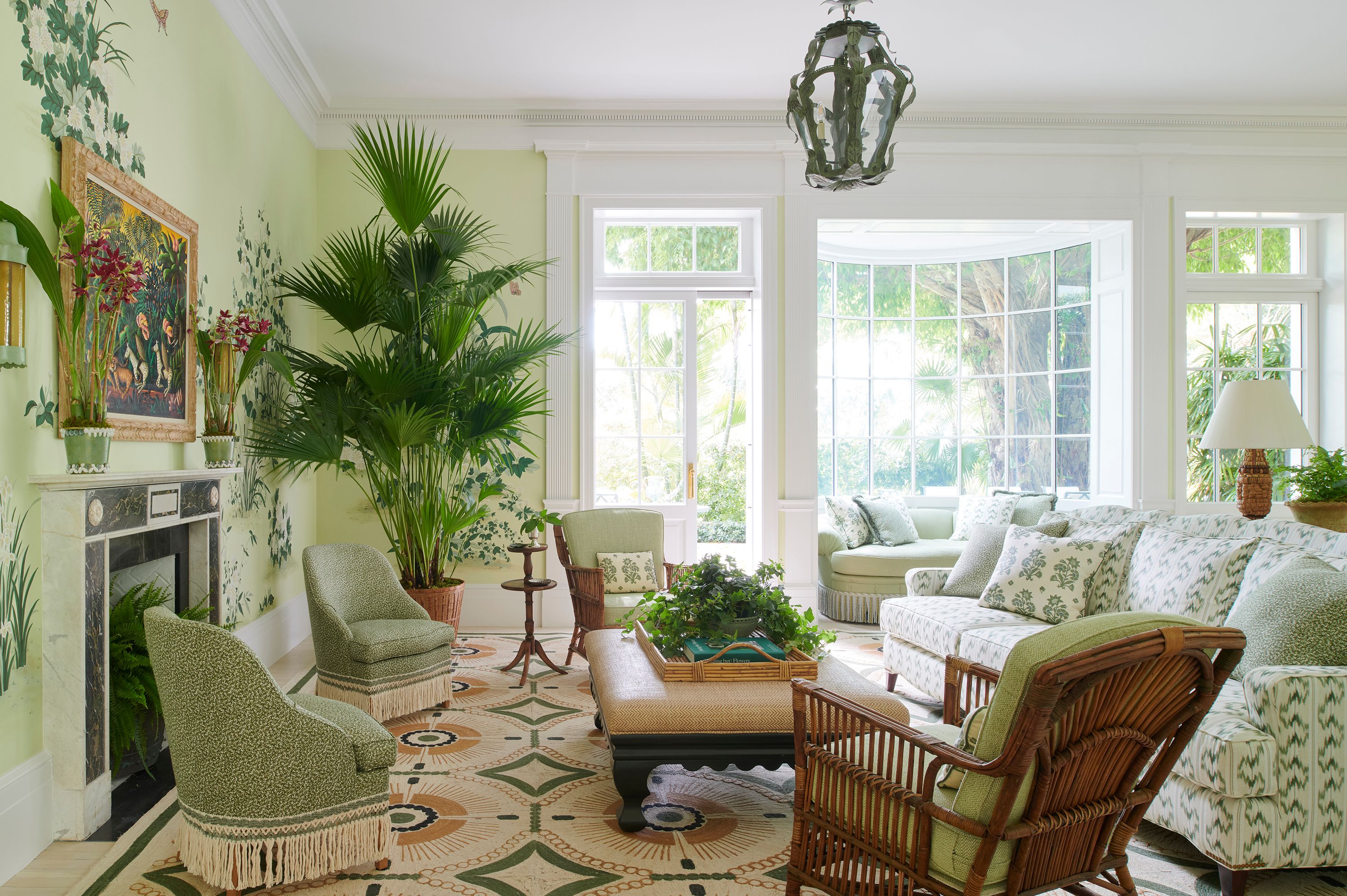 The deep-set J. Edlin Interiors window seat in the family room is a beloved reading spot. It is upholstered in a pale seafoam Kravet textile and finished with Samuel & Sons bouillon fringe. The larger sofa in the foreground is from Grafton Furniture and is upholstered in a printed Leah O’Connell fabric. The Cintra ottoman from Woodbridge was painted in a custom green and upholstered in a Lance Wovens fabric. A scintillating Orville Bulman painting hangs above the mantel. The slipper chairs under it are by Nickey Kehoe and upholstered in a Holly Hunt fabric.