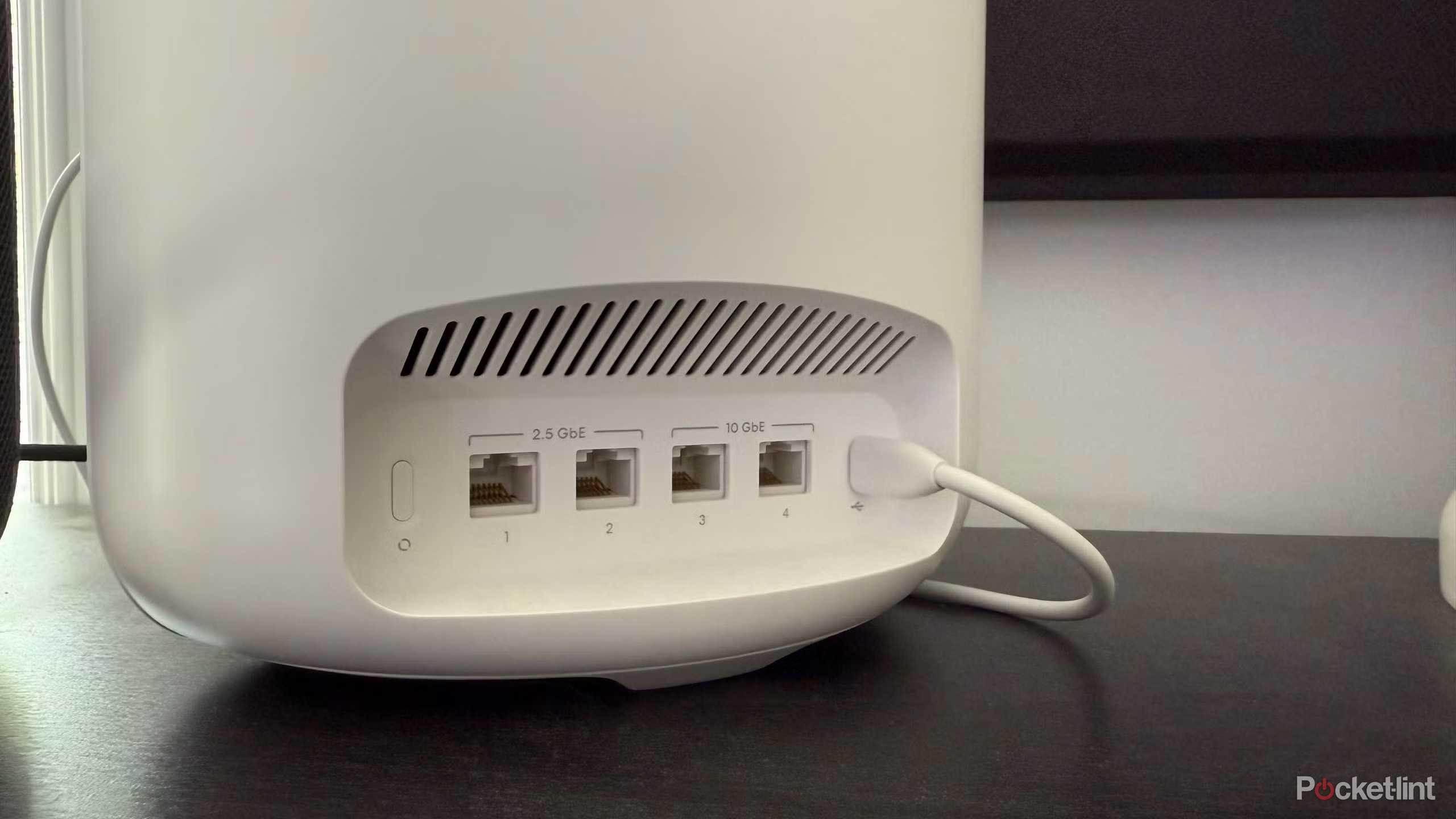 Ethernet ports on the back of a Wi-Fi router.