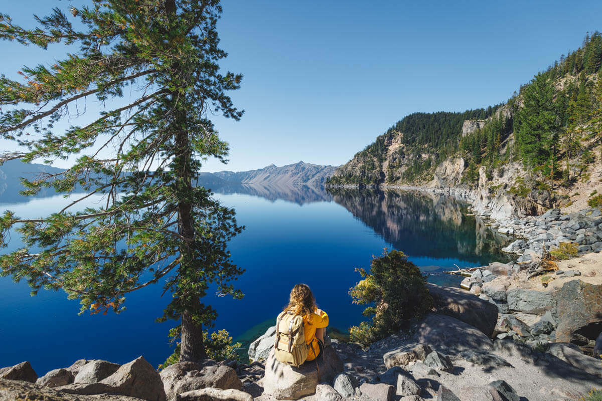 Sitting on the rocks along the Cleetwood Cove Trail overlooking Crater Lake