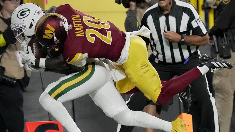 Green Bay Packers wide receiver Jayden Reed (11) is injured while being tackled by Washington Commanders safety Quan Martin.