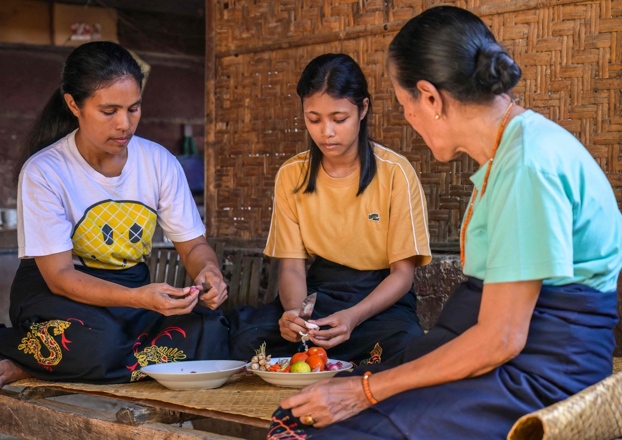 Rambu Margaretha (right) looks on as two of her