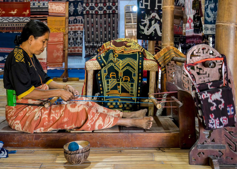 A woman weaves traditional