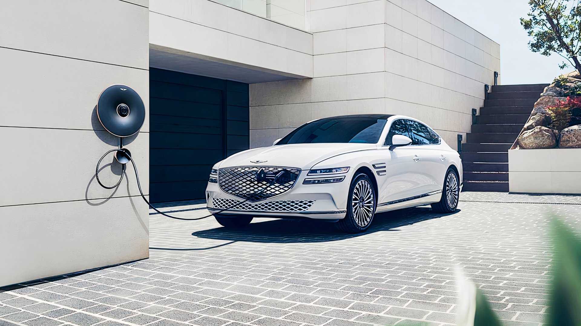 A white 2024 Genesis Electrified G80 electric sedan is parked.