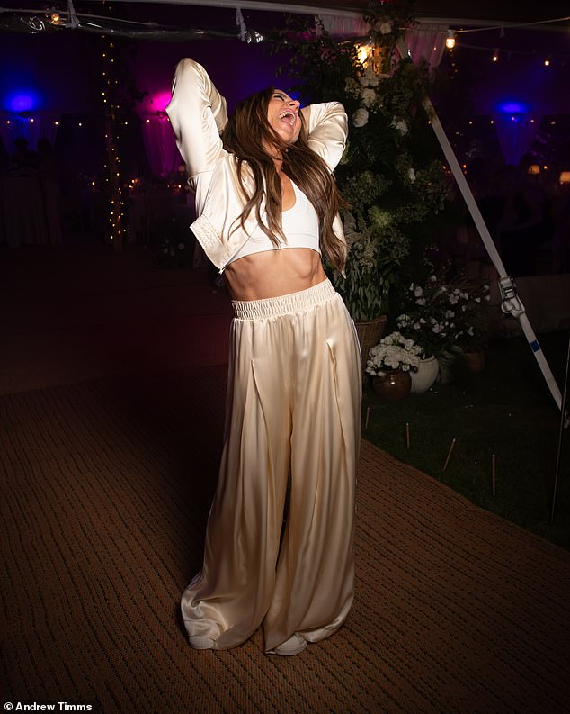After the meal, Melanie changed into another custom Adidas look — an elevated interpretation of a tracksuit, with high-waisted, wide-legged trousers and a cropped jacket featuring a peaked lapel and deep ribbed waistband