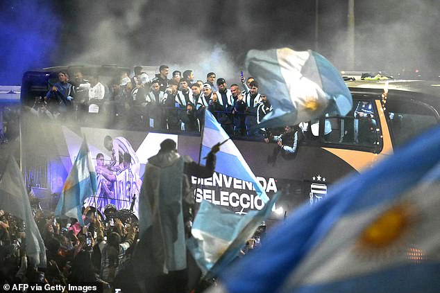 Argentina's national football team rides aboard an open-top bus as it arrives at the Argentine Football Association (AFA) training camp in Ezeiza, Buenos Aires Province, on July 20, 2026