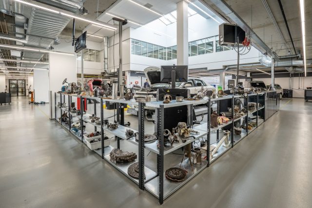 Spacious auto workshop showcasing various car parts and repair equipment.