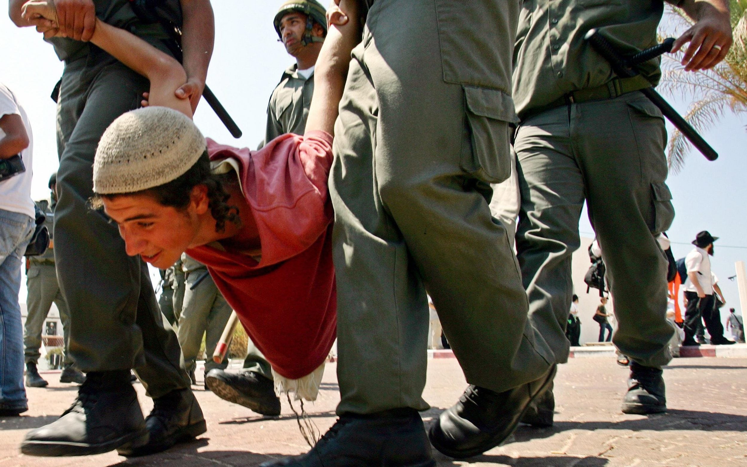 June 2005: Israeli policemen forcibly evacuate a Jewish settler from the Gush Katif bloc