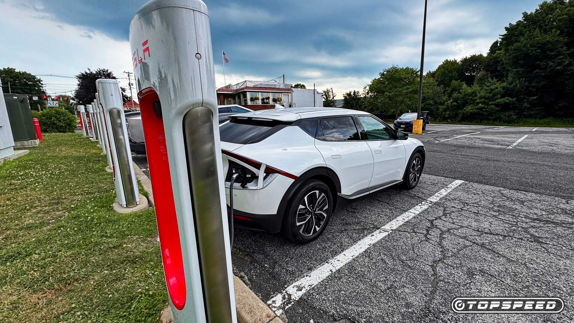 Rear shot of a Kia EV 6 at Tesla Supercharger
