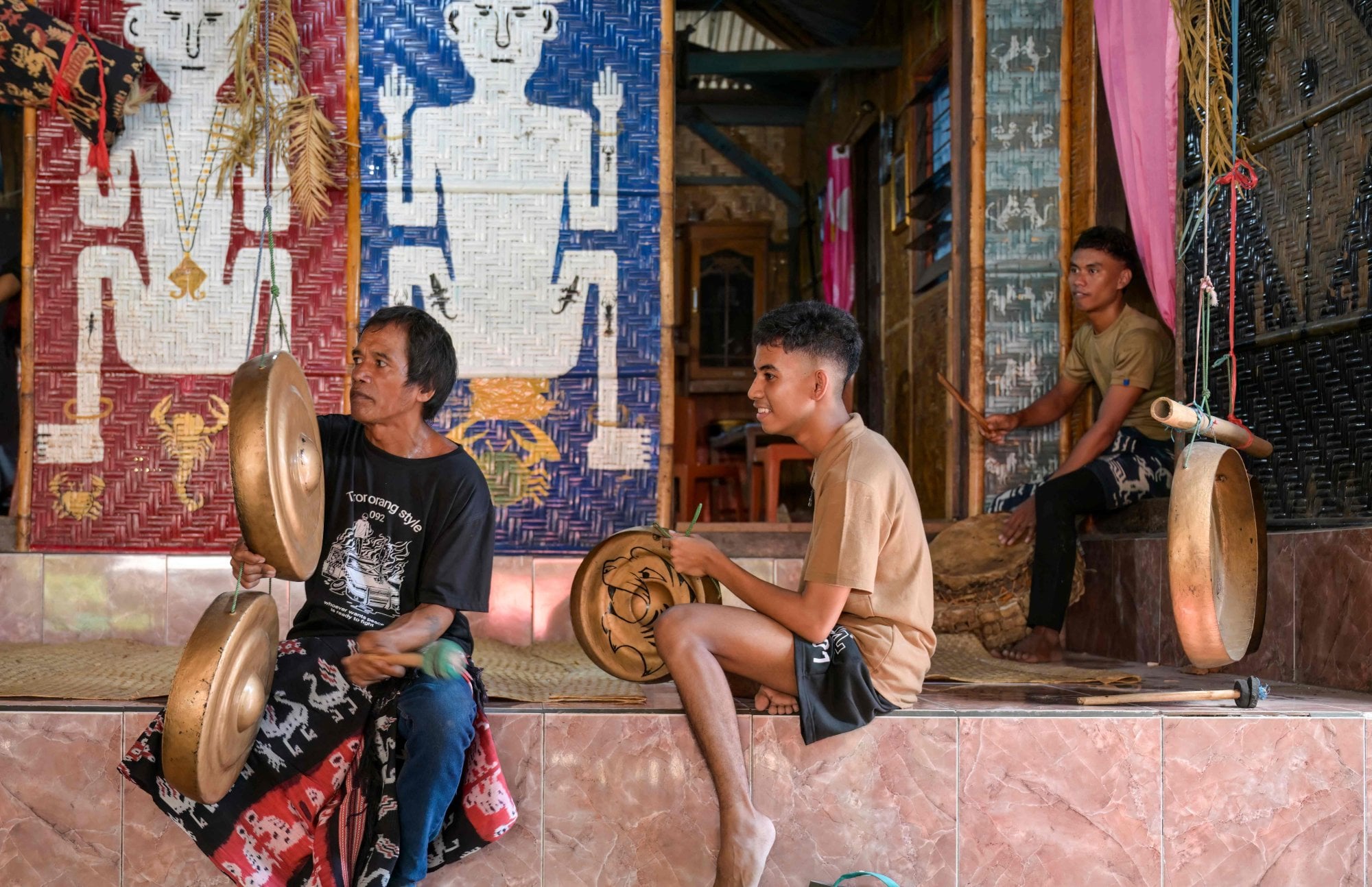 Men play traditional musical instruments during a