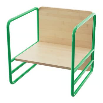 Children's wooden chair with green metal frame, featuring a backrest and armrests. Suitable for playrooms or classrooms
