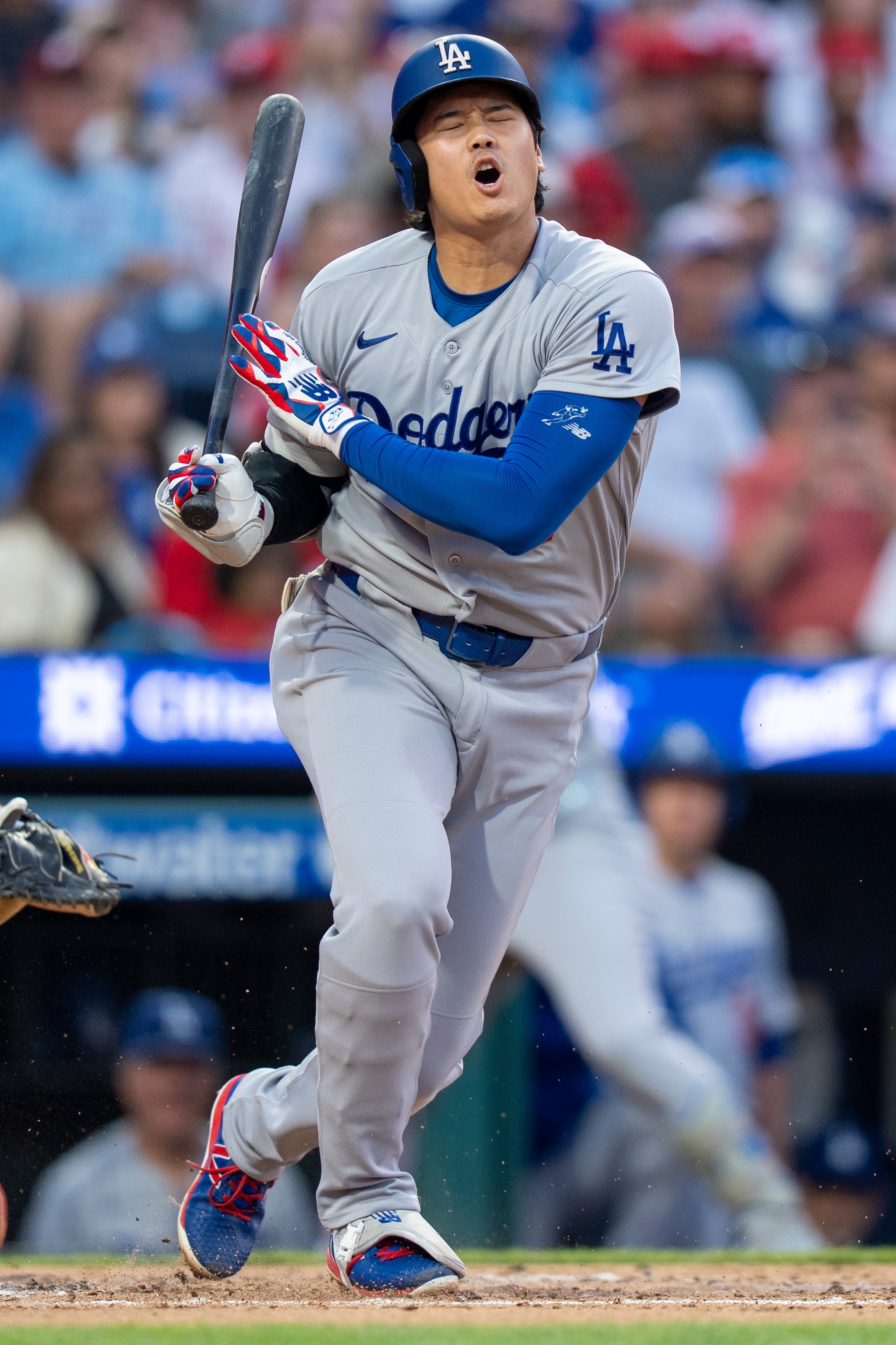 Los Angeles Dodgers' Shohei Ohtani reacts to fouling the ball off his body during the third inning of a baseball game against the Philadelphia Phillies, Monday, July 20, 2026, in Philadelphia. (AP Photo/Chris Szagola)