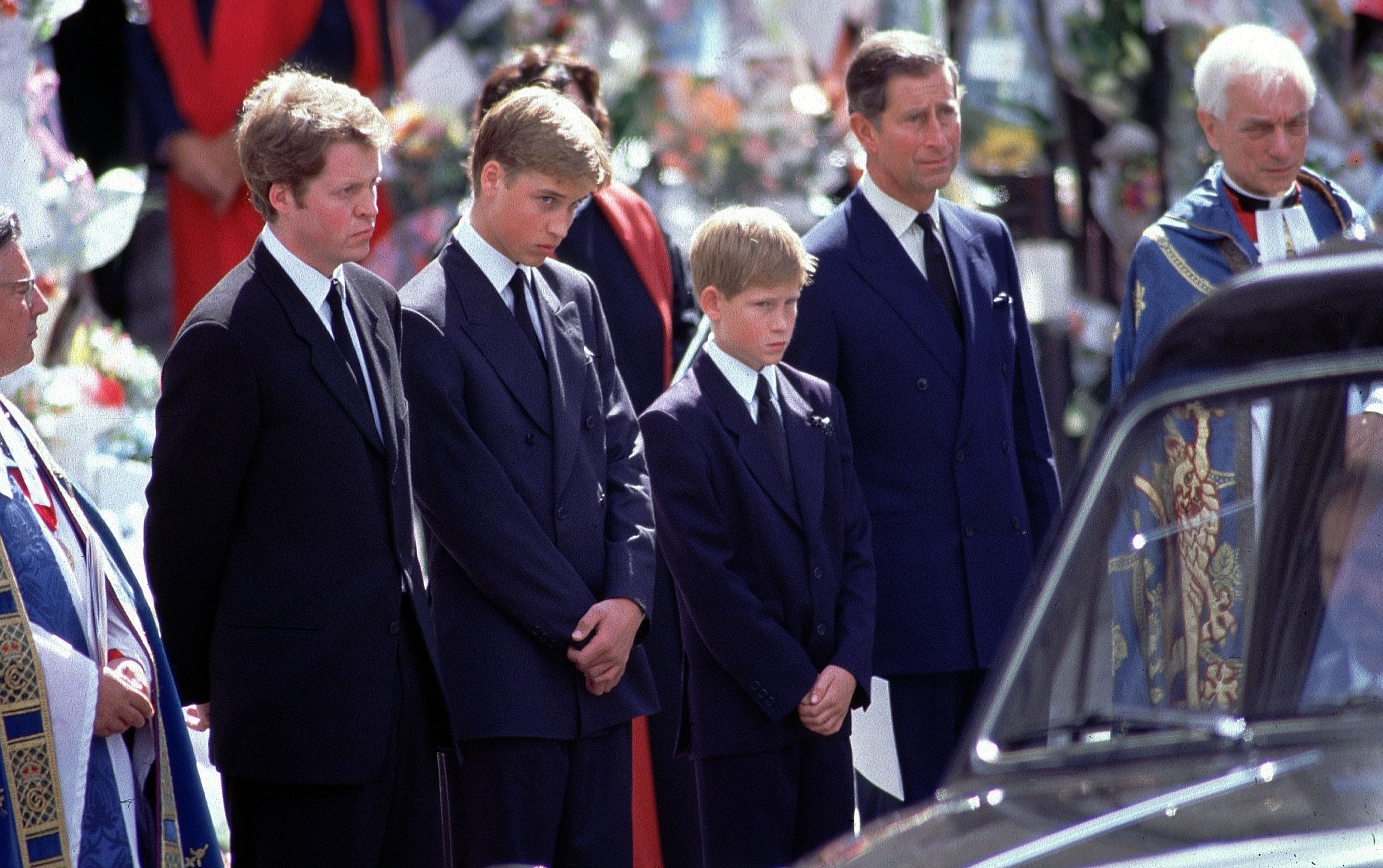 Earl Spencer, Prince William, Prince Harry and Prince Charles stand alongside the hearse containing the coffin of Diana after the funeral service at Westminster Abbey