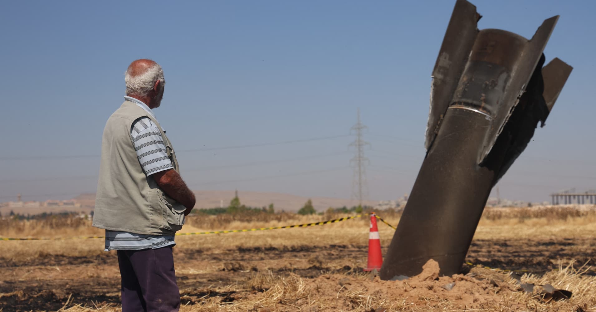 A Syrian farmer looks at an Iranian missile that fell into an agricultural land in the area of Najha, in the countryside of the Syrian capital after being intercepted by Israeli air defense systems on June 8, 2026.