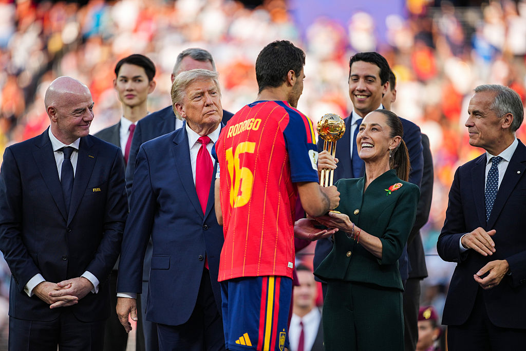 EAST RUTHERFORD, NEW JERSEY - JULY 19: Mexican President Claudia Sheinbaum presents Rodri #16 of Spain with the Golden Ball award alongside (L-R) FIFA President Gianni Infantino, U.S. President Donald Trump, and Canadian Prime Minister Mark Carney during the awards ceremony after the FIFA World Cup 2026 Final match between Spain and Argentina at New York New Jersey Stadium on July 19, 2026 in East Rutherford, New Jersey. Spain defeated reigning World Cup champions Argentina, who were led by Lionel Messi, with the lone goal coming from Ferran Torres #7 in the 106th minute of extra time. (Photo by Andrew Harnik/Getty Images)