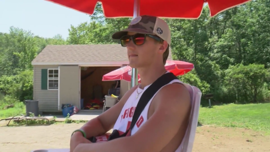 Teenage lifeguard keeping swimmers safe at local park