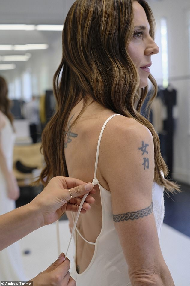 Mel flashed her inked skin in her elegant wedding gown