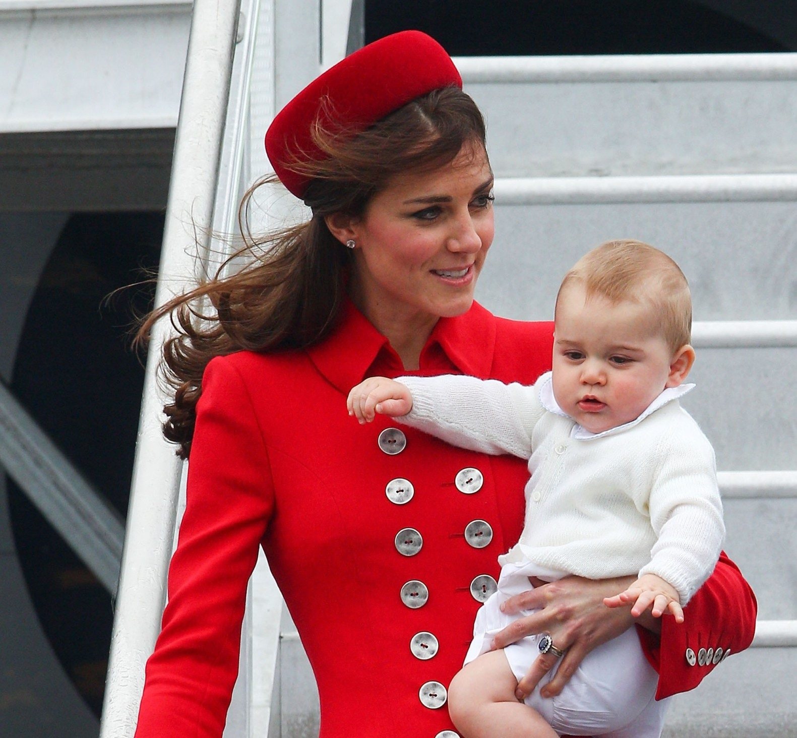 Catherine, then the Duchess of Cambridge, exiting a plane with a baby Prince George on April 7 2014