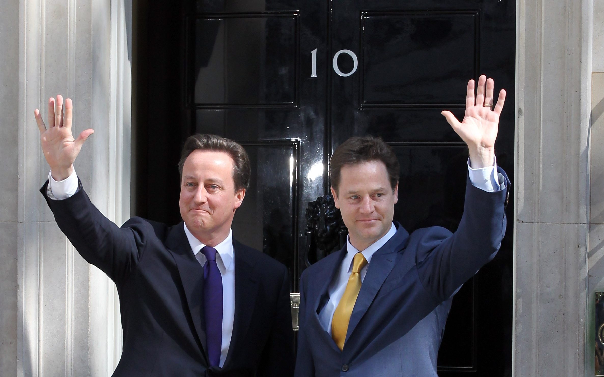 David Cameron welcomes Nick Clegg to Downing Street for their first day of coalition government on May 12, 2010
