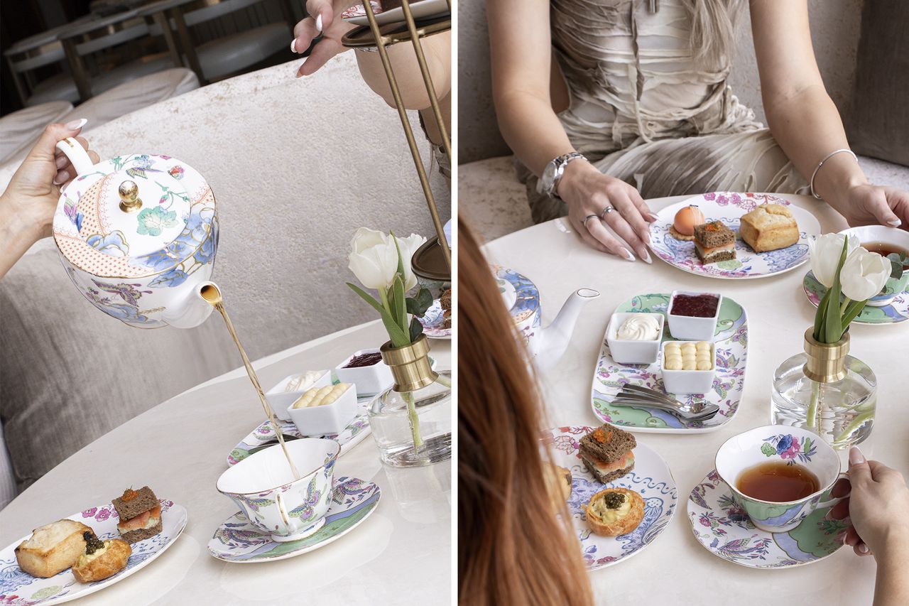 Afternoon tea setup with tea being poured accompanied by pastries and condiments