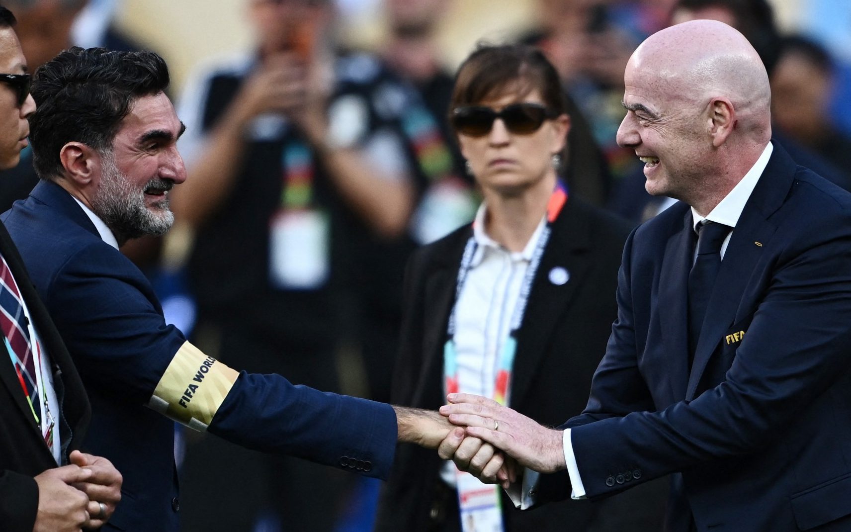 Newcastle United chairman Yasir Al-Rumayyan shakes hands with FIFA President Gianni Infantino during the trophy presentation
