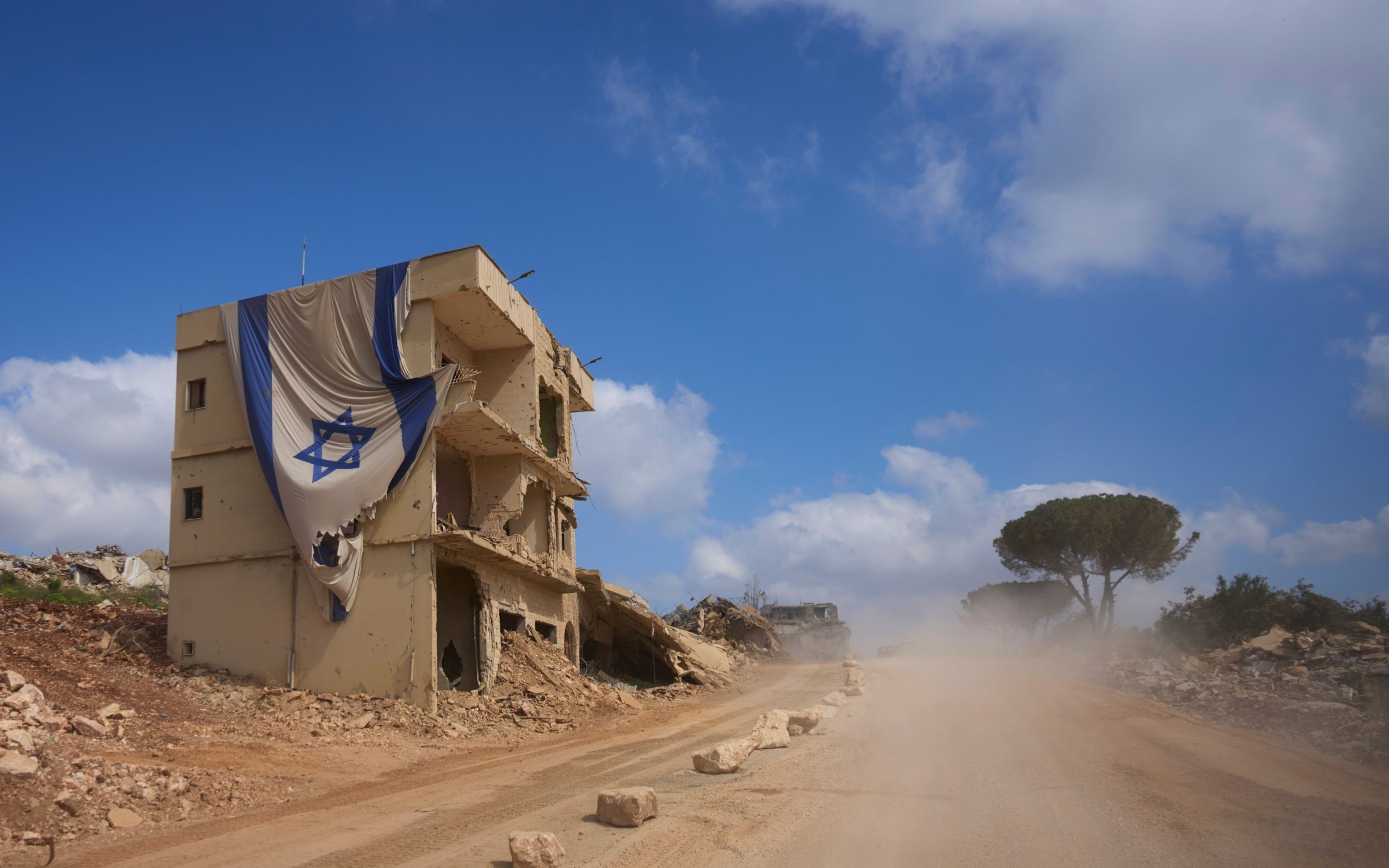 An Israeli flag hangs from a building in an area occupied by Israeli troops in southern Lebanon