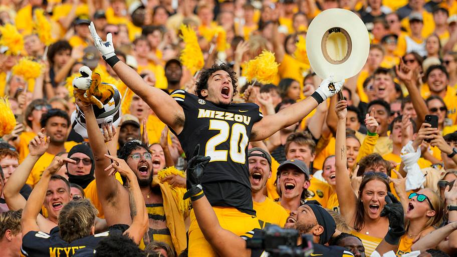Mizzou football player celebrates with the crowd in a victory.