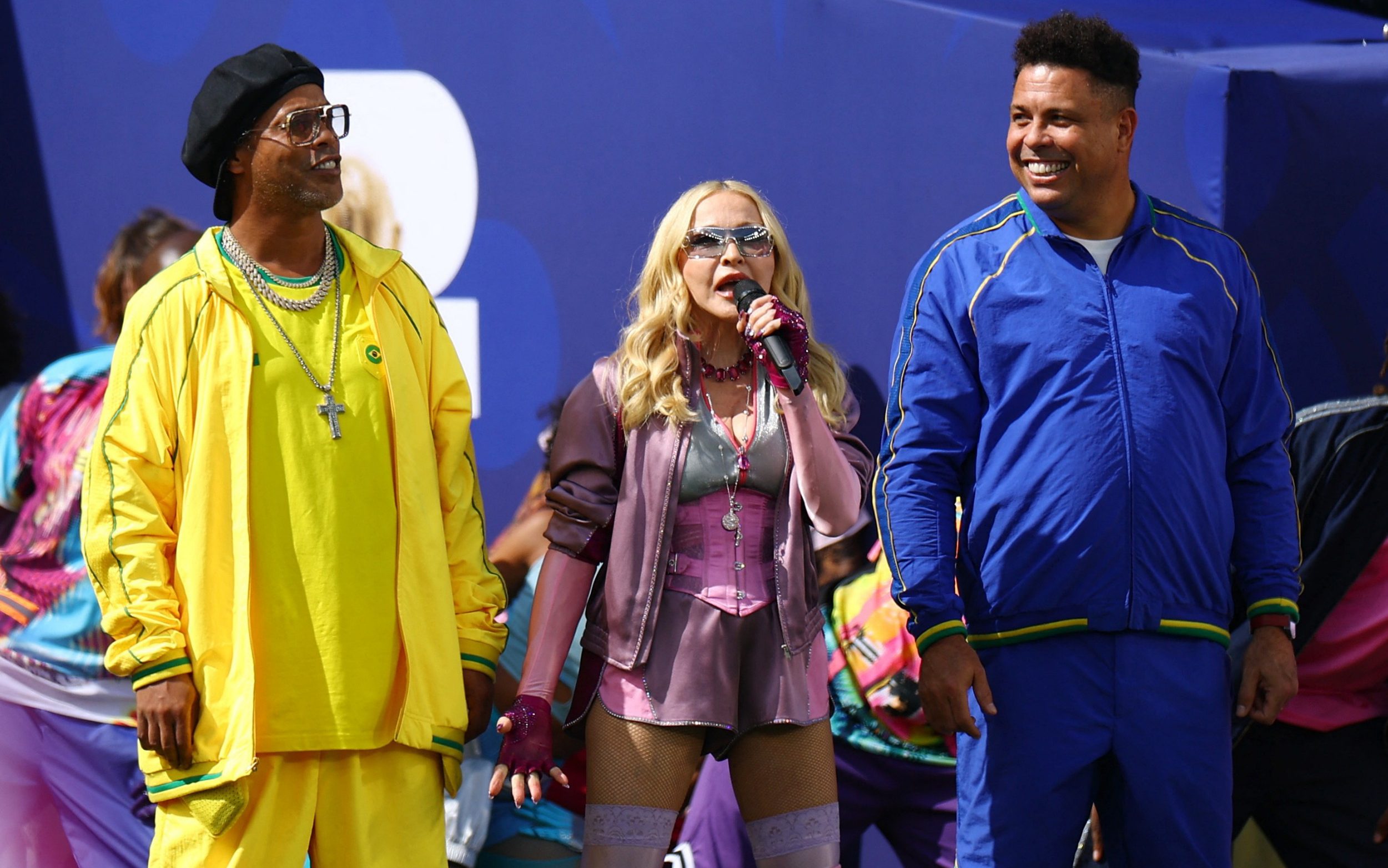 Madonna, flanked by Ronaldo and Ronaldinho, sings