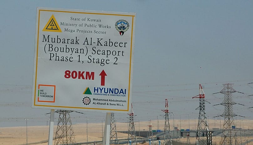 In this Aug. 20, 2011 photo, a sign is displayed leading to the construction site at the Mubarak al-Kabir port project on Bubiyan Island, Kuwait. Iraq and Kuwait, two countrie
